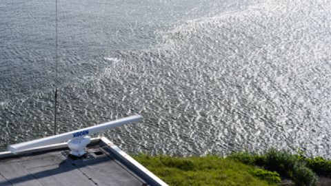 View of the radar on the Coast Guard tower with a front visible in the river