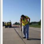 Graduate student, Paul Imbrock, applies SME sealant to a pavement joint for a field trial on US 231 in Lafayette, IN